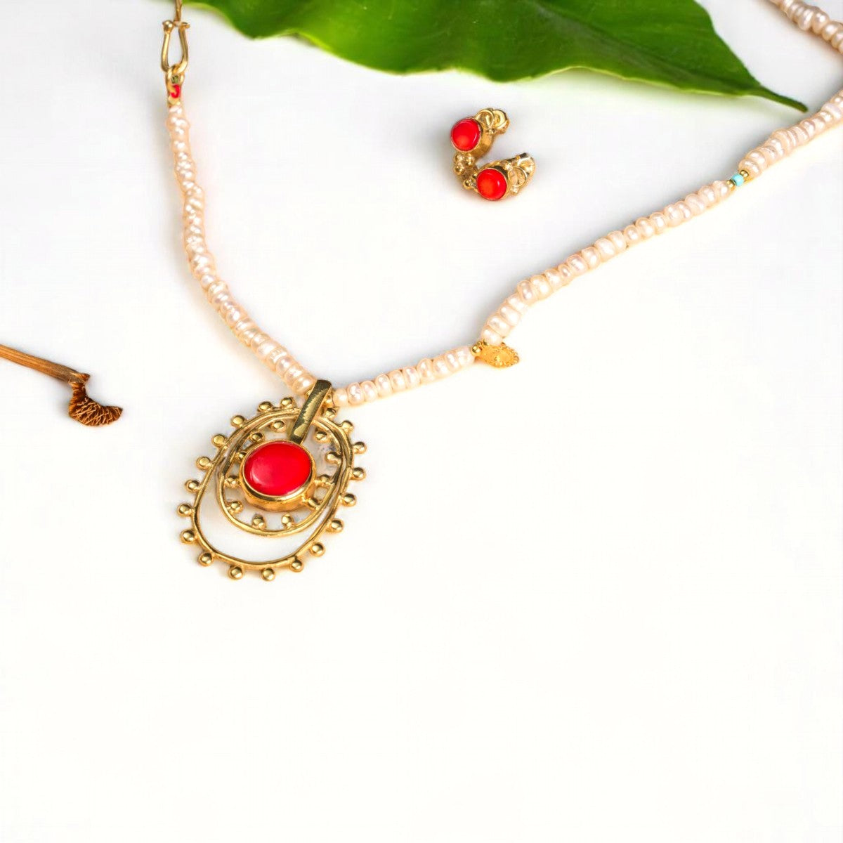 Elegant Fairy Tale necklace featuring pearl beads, coral gemstone pendant, and matching earrings, crafted beautifully.