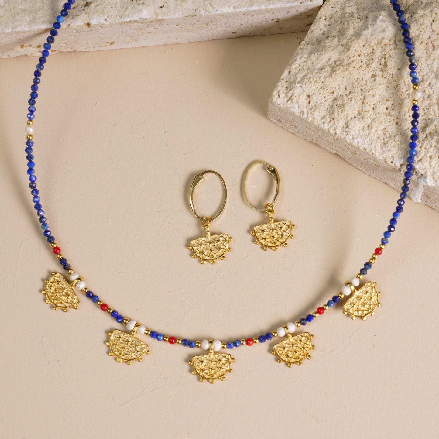 Hittite Sun Symbol necklace and earrings set with Lapis Lazuli gemstones, featuring intricate gold pendants and detailing.