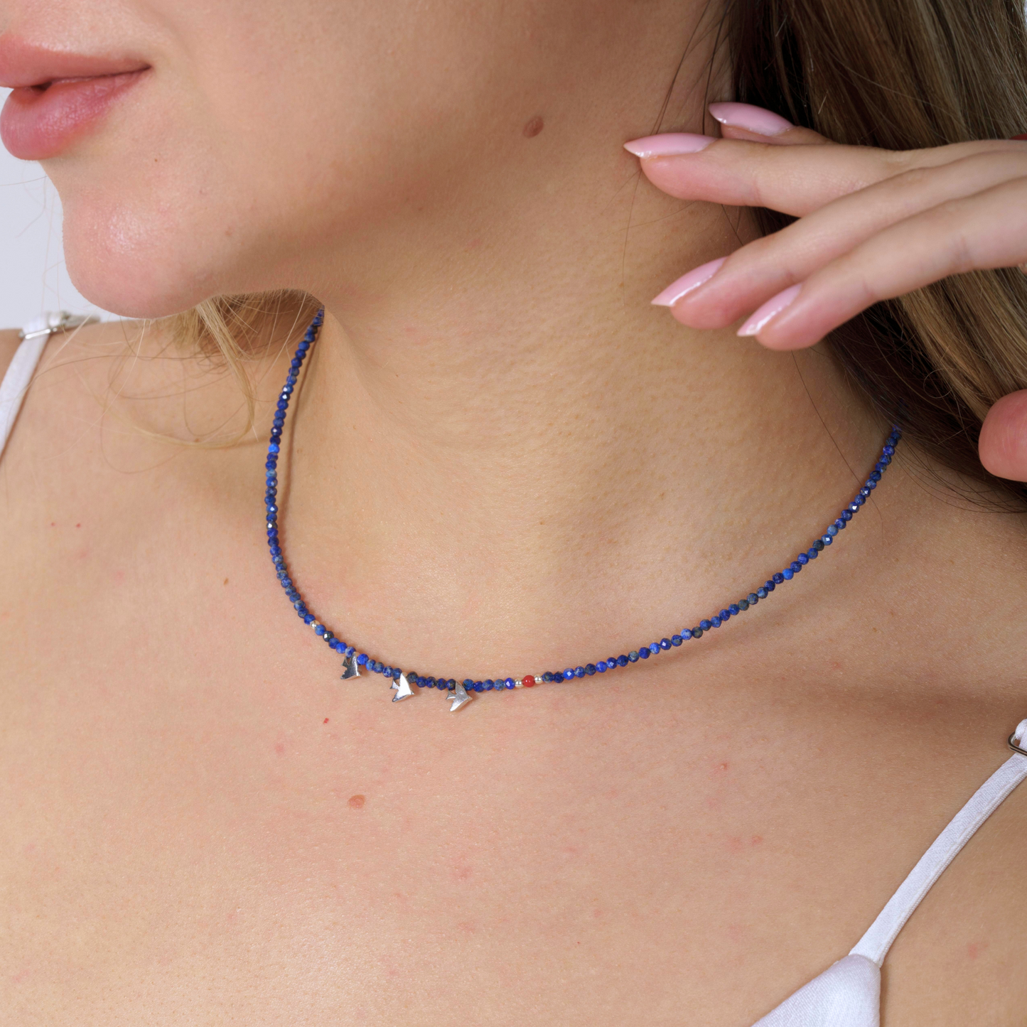 Minimal Lapis Lazuli Gemstone Necklace with Silver Three Bird Pendants, elegantly displayed on a model's neck.