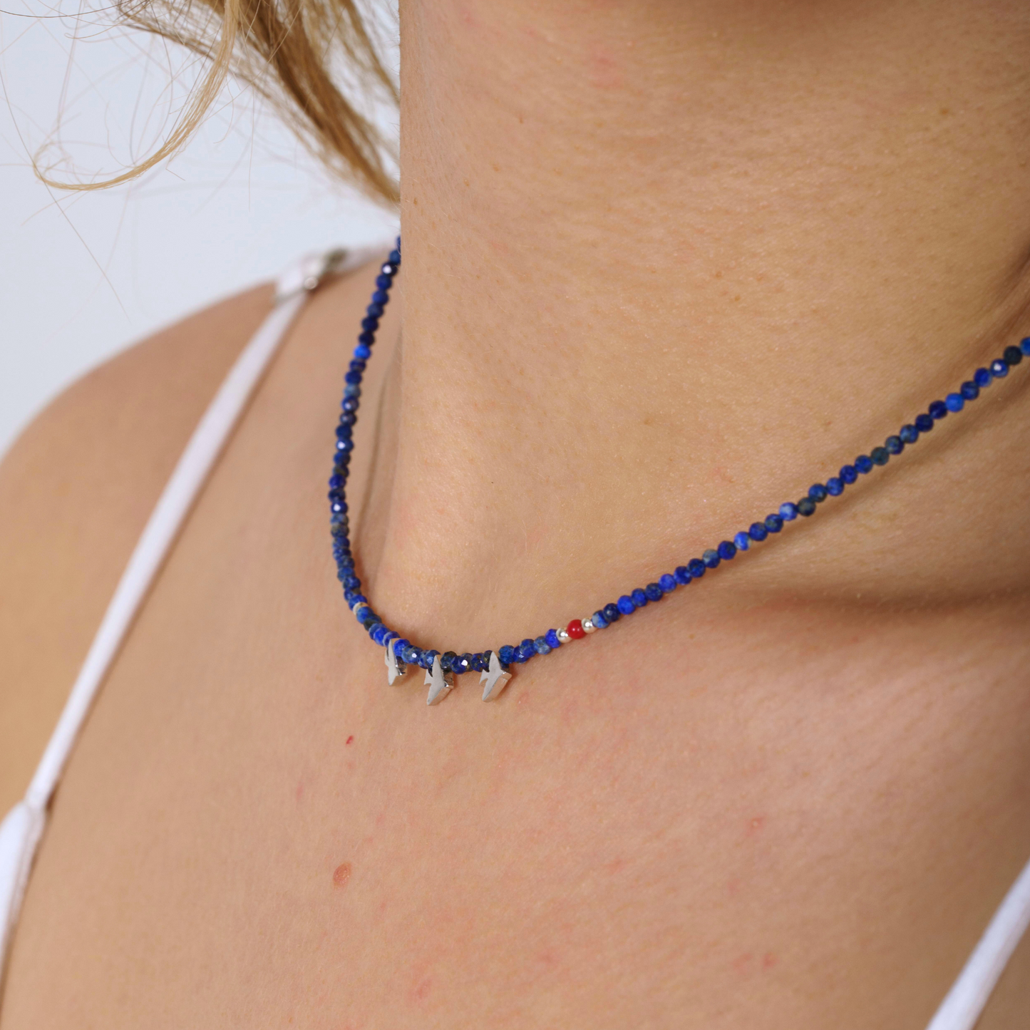 Minimal Lapis Lazuli gemstone necklace with elegant silver bird pendants, styled for a modern and sophisticated look.