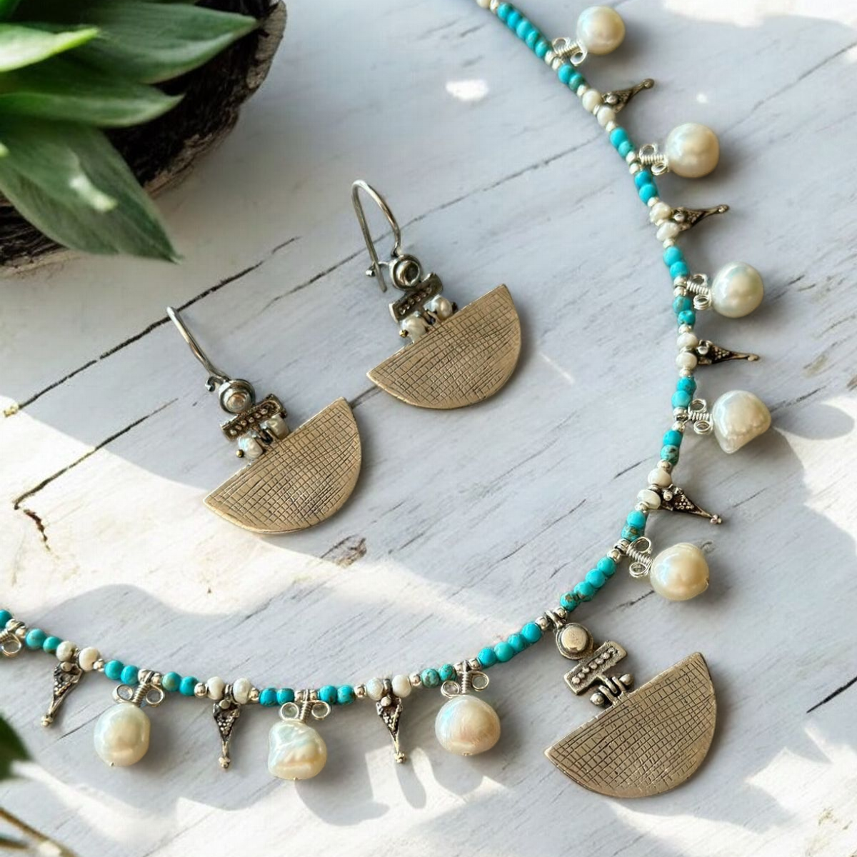 Selena Turquoise Necklace and Earrings Set featuring intricate turquoise beads, delicate pearls, and brass half-moon pendants.