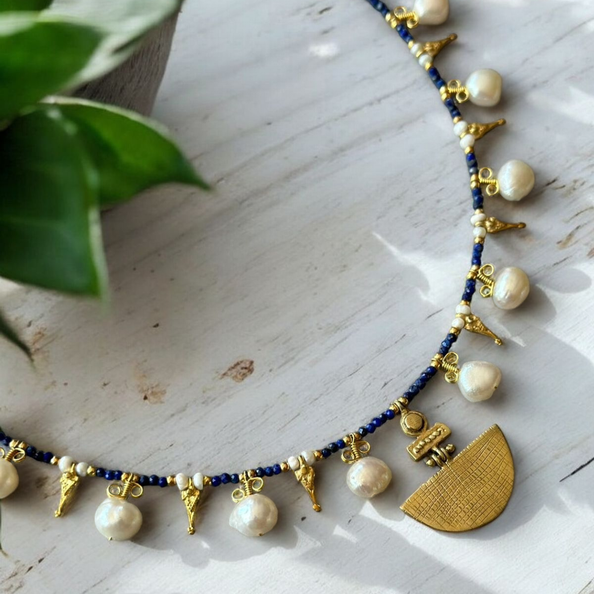 Selene Lapis Lazuli Gemstone and Pearl Necklace with Gold Plating displayed on a white surface.