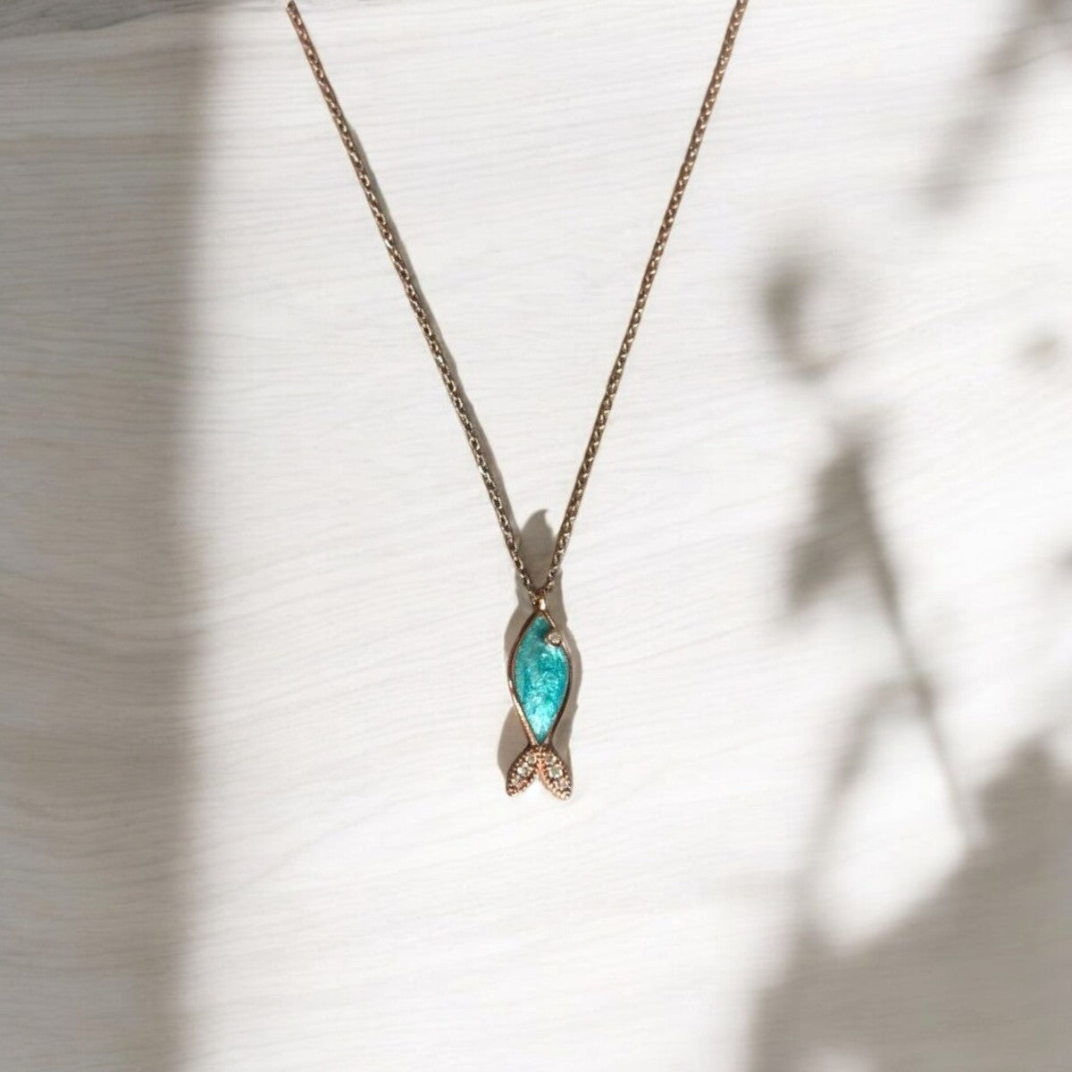 Azure Silver Fish Necklace with handcrafted rose gold plating, elegant ocean-inspired jewellery piece on display.