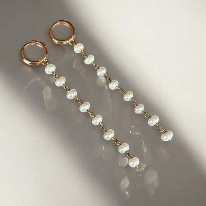 Elegant pearl long chain drop earrings featuring gold-tone hoops and a delicate pearl string design, perfect for formal wear.