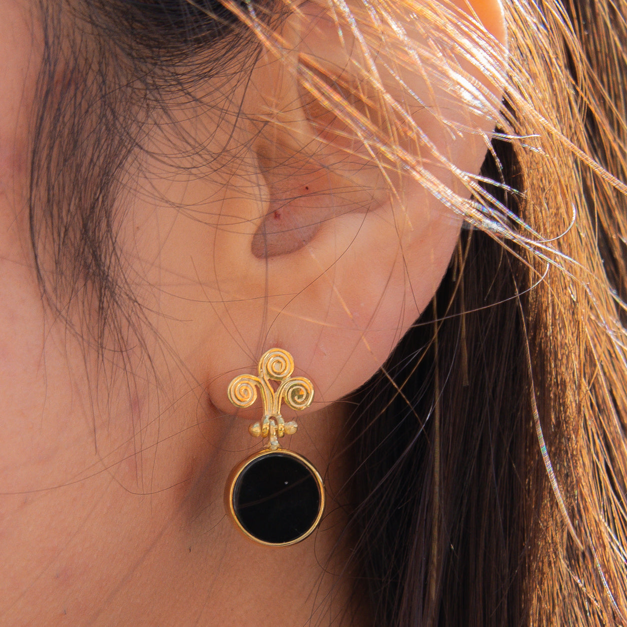 Rho Natural Onyx Gemstone Drop Earrings on ear showcasing intricate design and craftsmanship.
